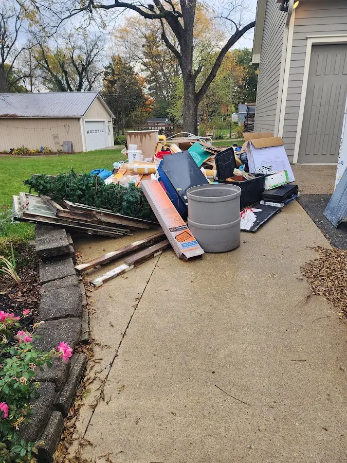Dumpster being loaded with debris for 30 Yard Dumpster Rental in Town and Country